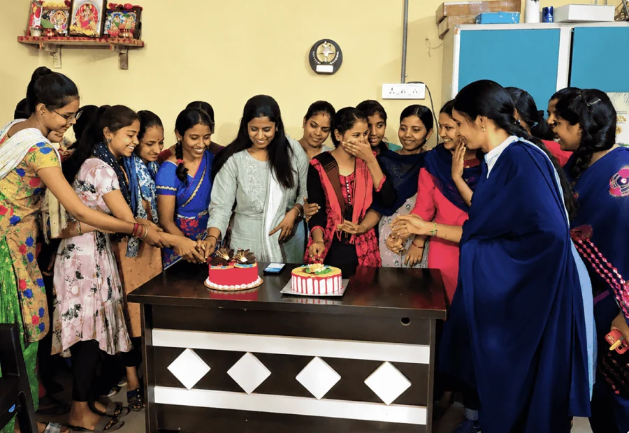 Colleagues gathered around a birthday cake in the office