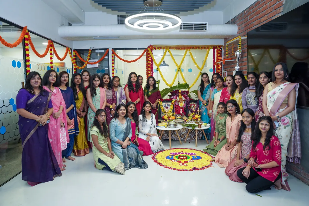Ripplrites gathered around the Ganesh Chaturthi shrine and rangoli in the office