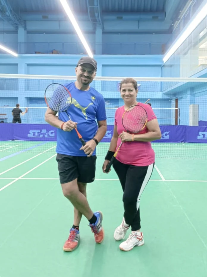 Two Ripplrites with rackets on the badminton court
